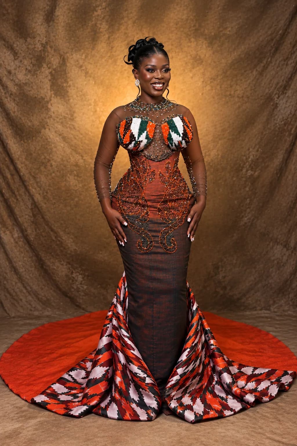 Client in a copper beaded tulle mermaid gown with a Kente-panel bust, densely beaded bodice and a train edged in red, black and white Kente cloth, photographed against a bronze backdrop.